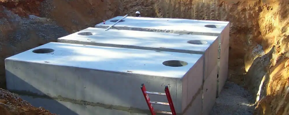 Septic tank installation site with a newly placed concrete tank in Dallas, TX